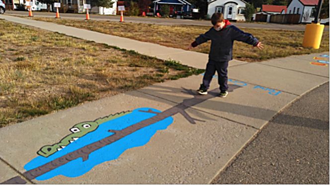 A student at Granby Elementary student takes a stroll down the new “sensory sidewalk” around the bus loop at the school.