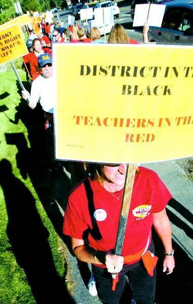 Picketing for pay: Teachers protest for better cost-of-living ...