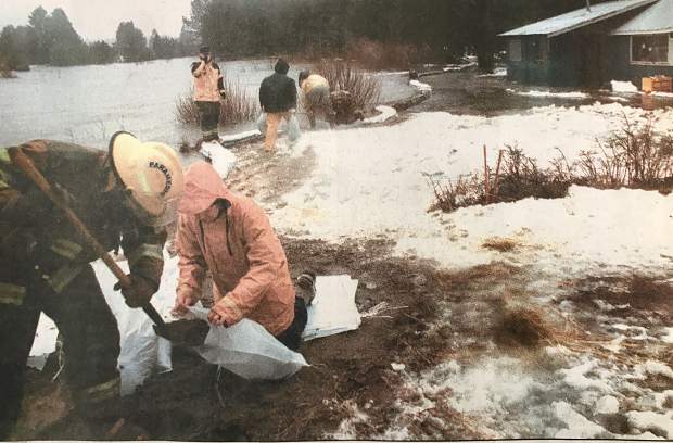 Lake Valley Fire Department personnel and residents who live along Sawmill Road try to stem the flow of the Upper Truckee River near U.S. 50 on Wednesday, Jan. 1, 1997.