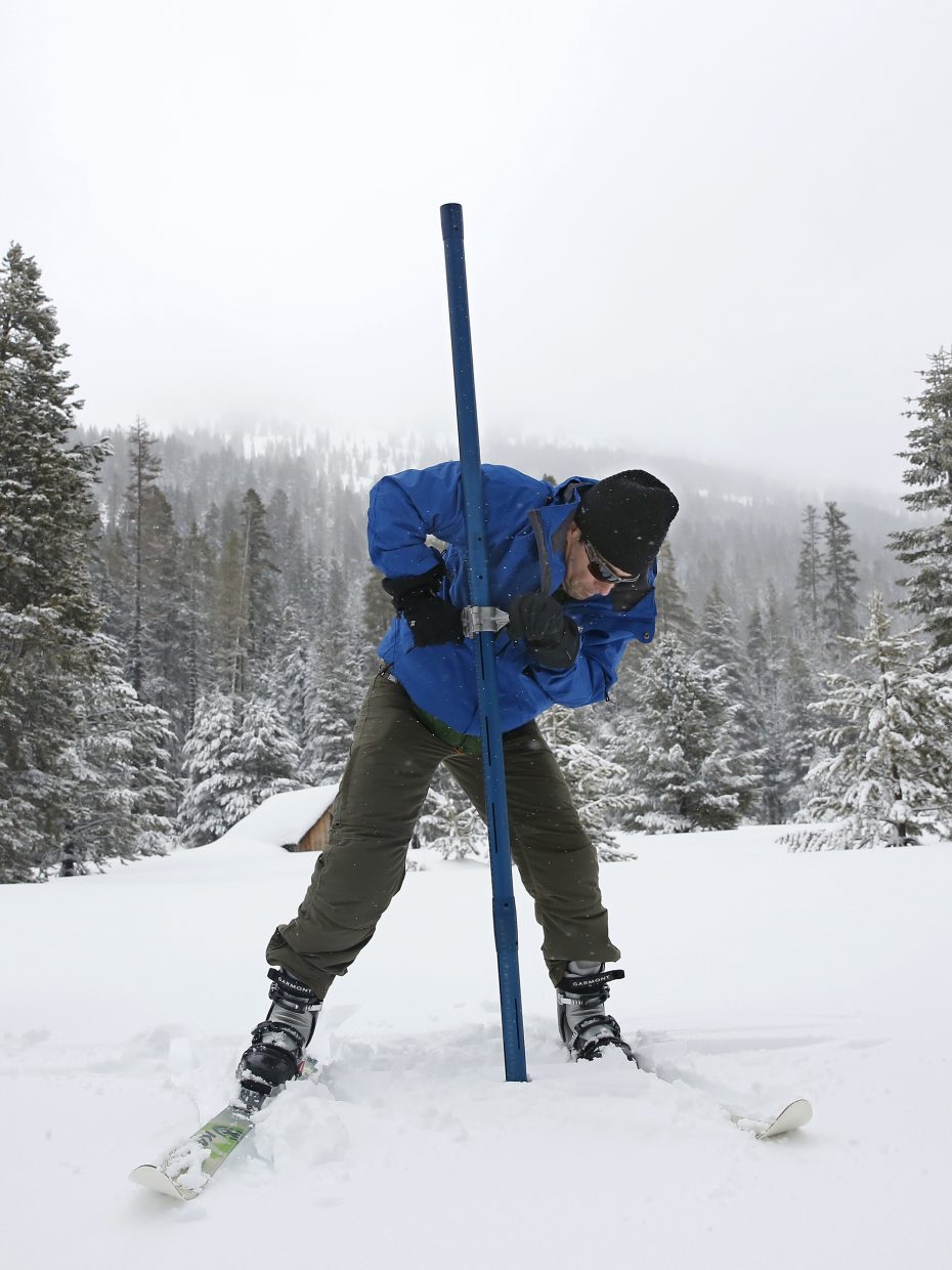 John King of the Department of Water Resources, thrust the snow survey tube into the snowpack while conducting the third manual snow survey of the season at the Phillips Station near Echo Summit, Calif., Thursday, Feb. 28, 2019. The survey found the snowpack at 113 inches deep with a snow water equivalent of 43.5 inches at this location at this time of year. 