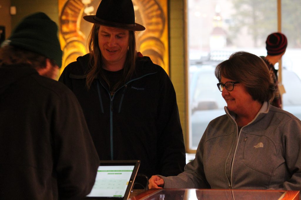 Mayor Brooke Laine makes the first legal adult-use cannabis purchase in South Lake Tahoe at Tahoe Wellness Cooperative Thursday, April 11. To the left is Cody Bass, Tahoe Wellness owner and South Lake Tahoe city councilor.